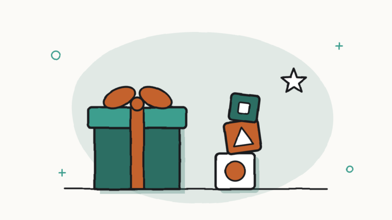 Caja de regalo con lazo y una torre de bloques de construcción