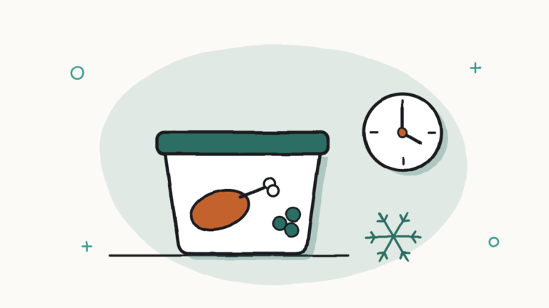 Fiambrera con comida, un reloj y un copo de nieve